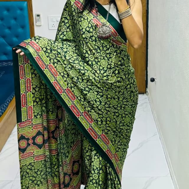 Green, black, red, and white Saree