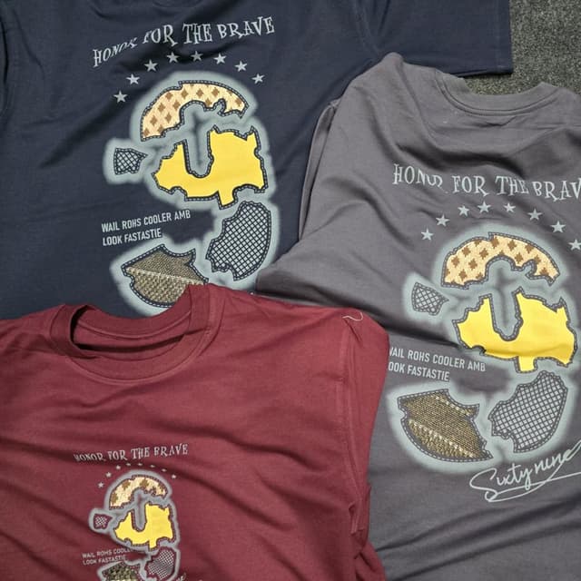 Various - Primarily dark blue, grey, and maroon with a yellow and brown graphic. T-Shirt