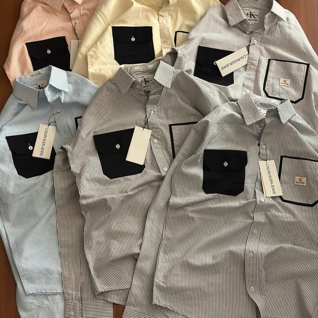 Various pastel colors including light pink, pale yellow, light blue, and grey, combined with black accents. Shirt