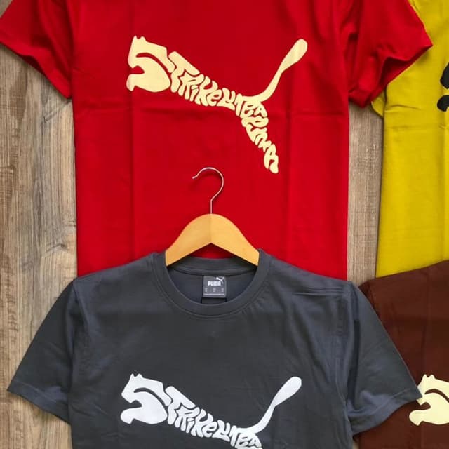 Red, Charcoal Gray, Yellow, and Brown with a white or off-white design. T-shirt
