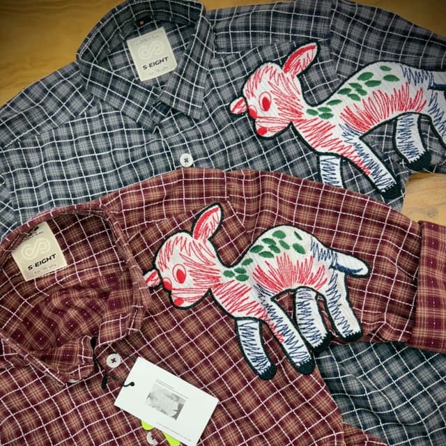 Burgundy and grey with white accents, embroidered with red, green, and blue details. Shirts