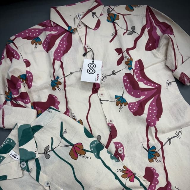Off-white base with a floral pattern in shades of fuchsia, burgundy, teal, and brown. Shirt