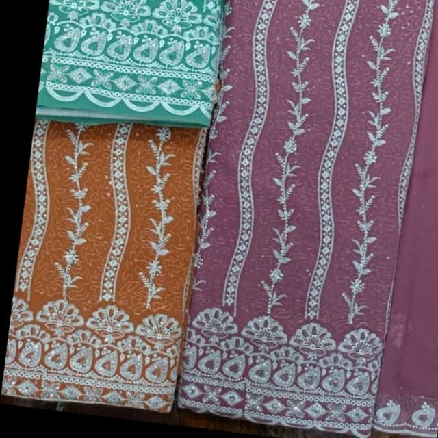 Rust orange, dusty rose, and teal with silver accents Unstitched fabric, likely for a salwar kameez or similar outfit.