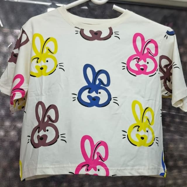 White, with accents of yellow, pink, blue, and brown T-shirt