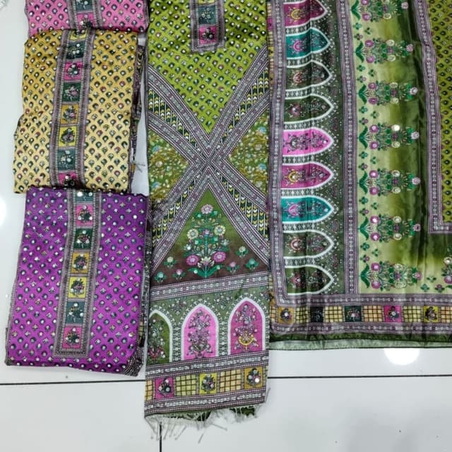 Various shades of green, pink, yellow, and purple with a touch of gold and white accents. Unstitched Salwar Kameez Suit