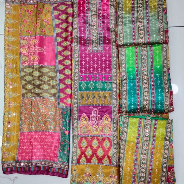 Multi-colored, featuring shades of pink, gold, green, and hints of red and brown. Unstitched Suit (likely a Salwar Kameez suit)