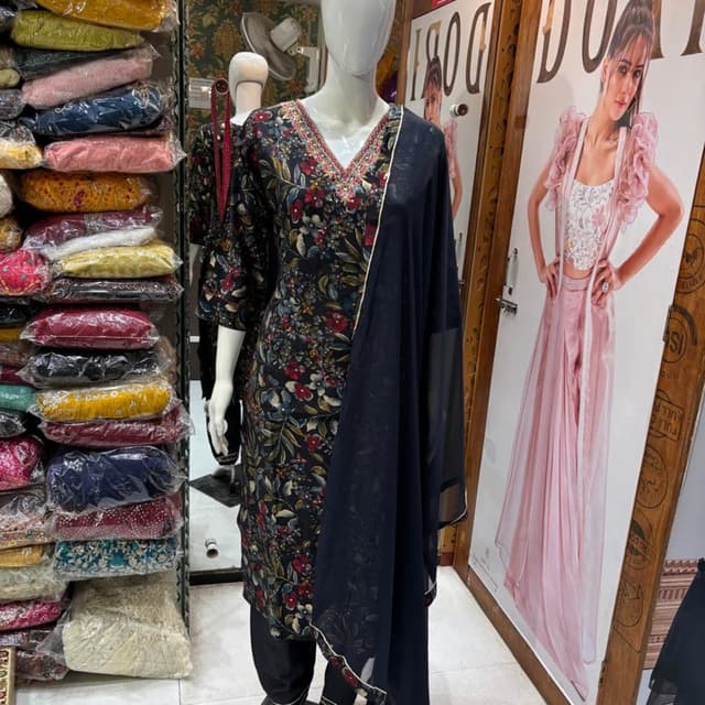 Black, with floral print in red, blue, and green, and a navy blue dupatta with gold trim. Salwar Kameez