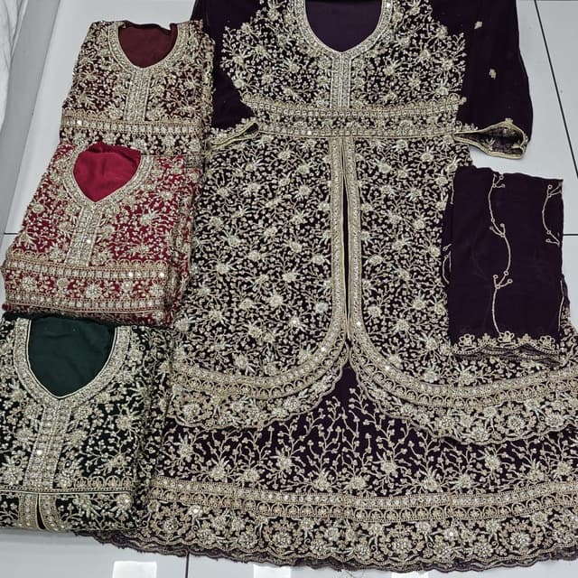 Various shades of burgundy, with golden embellishments, and some items appear in deep green and maroon. Anarkali Suit/Salwar Kameez