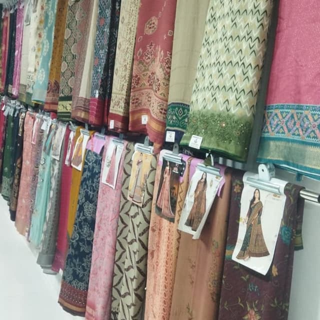 Various, including shades of red, pink, green, beige, blue, and brown. Sarees