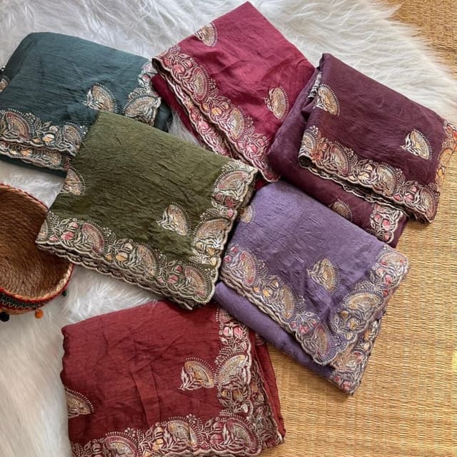 Various shades including burgundy, olive green, teal, and lavender. Saree or similar draped garment