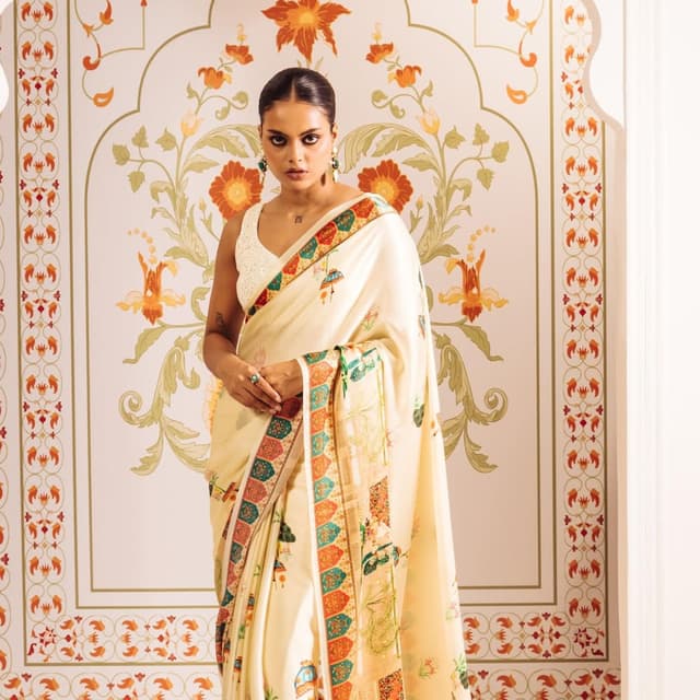 Ivory, with a border of red, green, blue, and gold accents. Saree