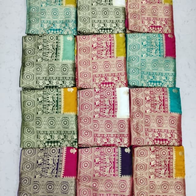 Various colors including teal, green, pink, yellow, and purple with gold accents. Sarees