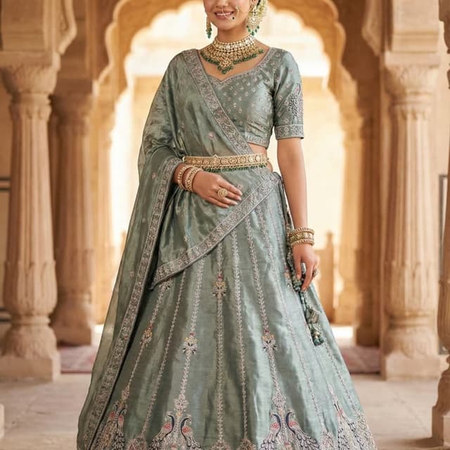 Sage green with accents of gold, pink, and other subtle colors. Lehenga Choli