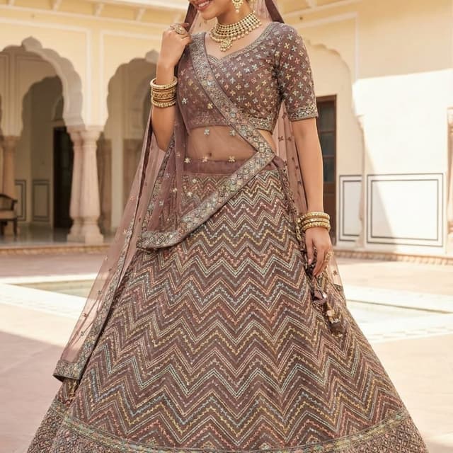 Brown, with accents of gold, green, and pink Lehenga Choli