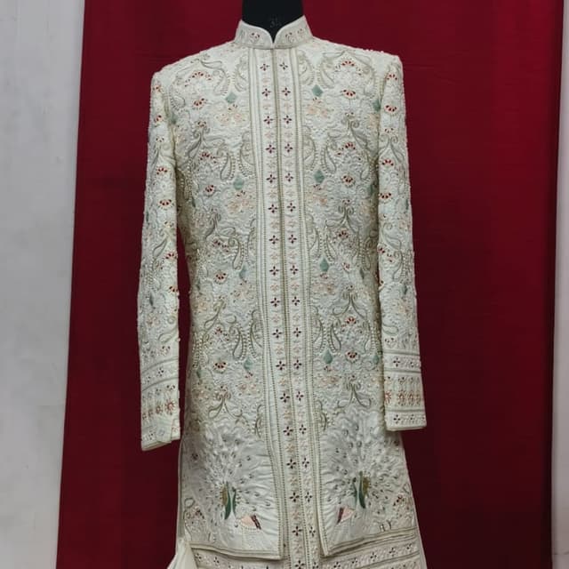 Ivory, with accents of green, red, and gold Sherwani