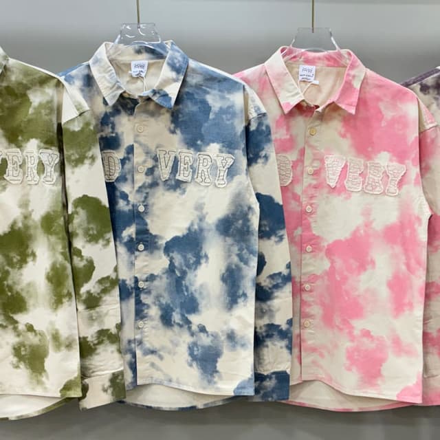 Various pastel shades (pink, blue, green) combined with white, creating a tie-dye or cloud-like effect. Shirt