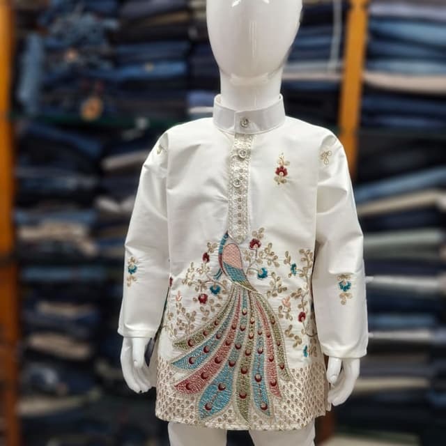 Ivory white, with accents of teal, pink, gold, and other pastel colors. Kurta