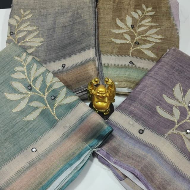 Various shades of grey, green, brown, and purple with hints of other colors Saree