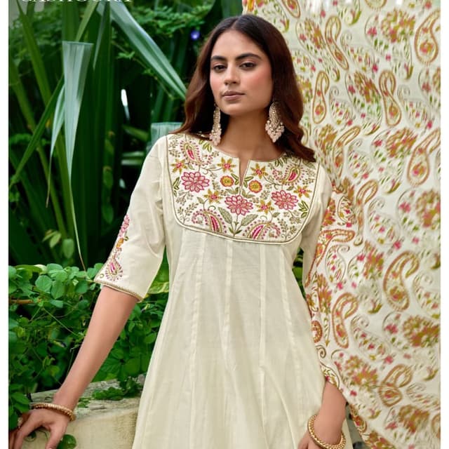 Off-white base with pink, green, yellow, and gold embroidery Anarkali Kurti