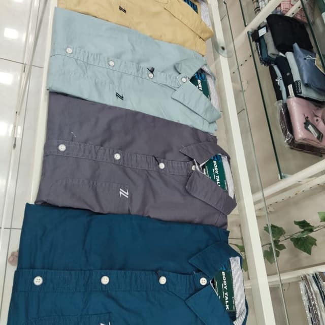 Various solid colors including teal, gray, light blue, and beige. Shirt