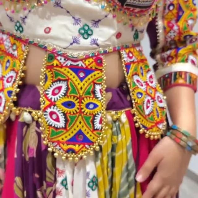 Multicolor, featuring black, white, red, yellow, purple, and green. Dress/Outfit