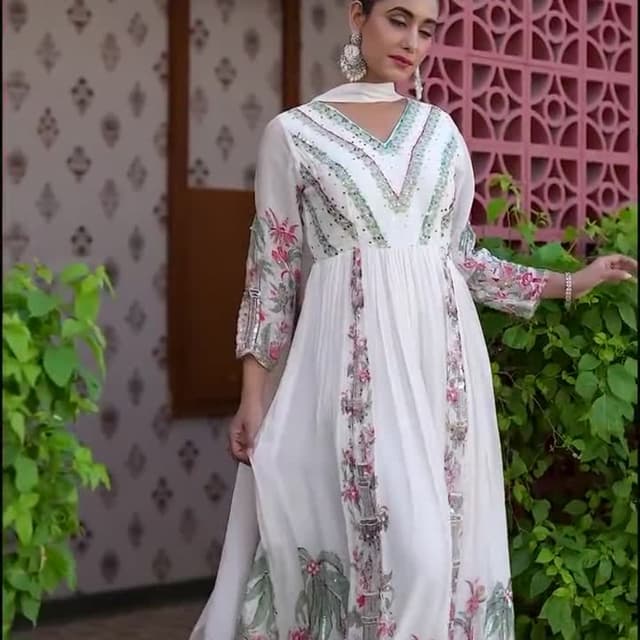 White, with accents of pink, green, and silver Dress