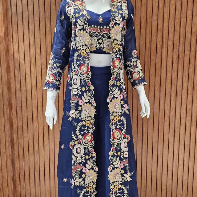 Navy blue, with floral embroidery in shades of red, yellow, pink, and off-white. Three-piece suit, including a crop top, trousers, and a long jacket