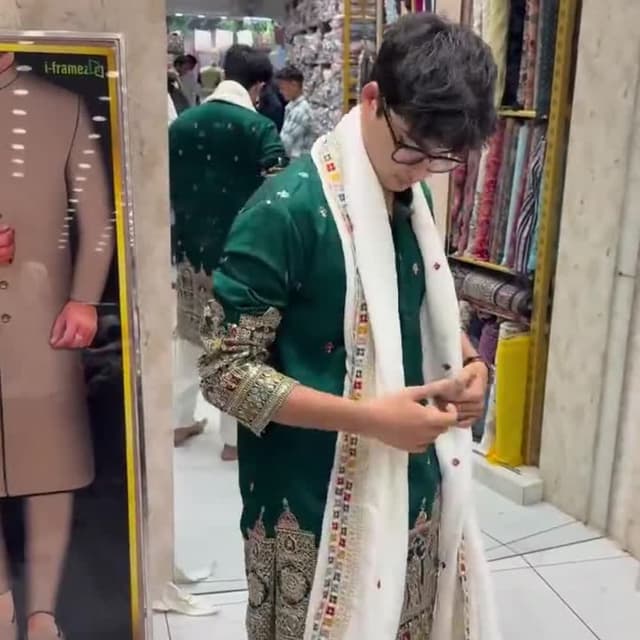 Green and white with gold accents and a multi-colored border Kurta and Shawl Set