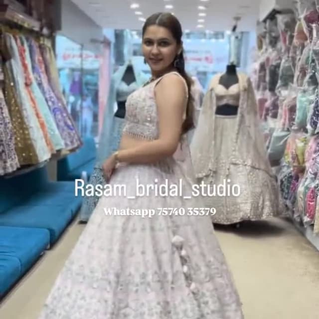 Ivory and subtle pastel hues (possibly light pink or mint green) for embroidery Lehenga Choli