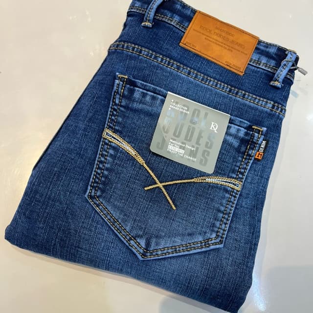 Blue with contrasting yellow/gold stitching and a brown leather patch Jeans
