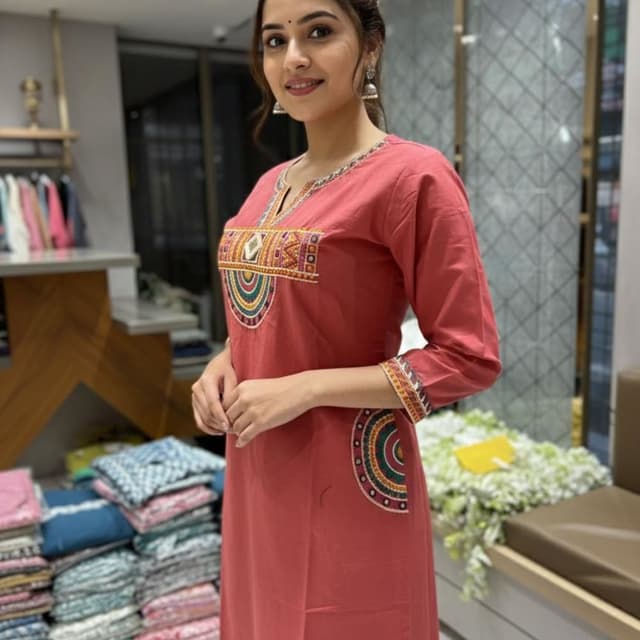 Coral Red, with accents of yellow, orange, green, and white embroidery Kurti