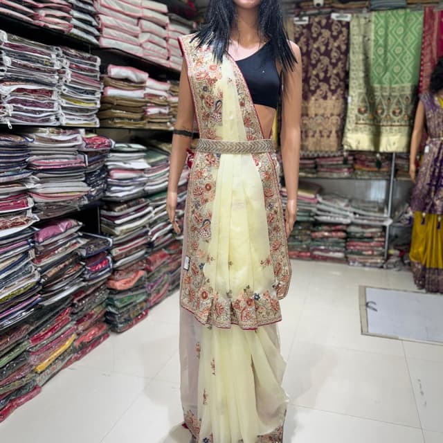 Pale yellow, red, cream, and touches of blue and gold Saree
