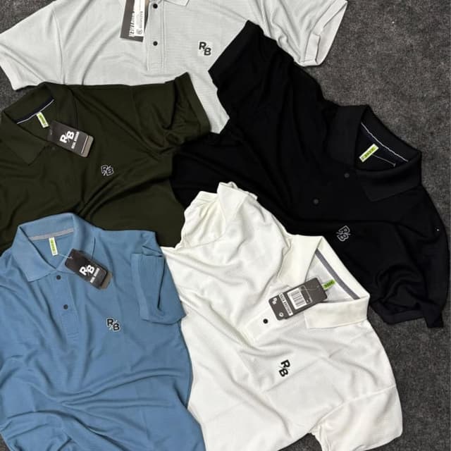 Various, including white, black, blue, and olive green Polo Shirt