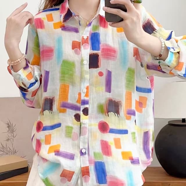 White with a vibrant abstract pattern in various colors including blue, green, orange, purple, red, and brown. Shirt