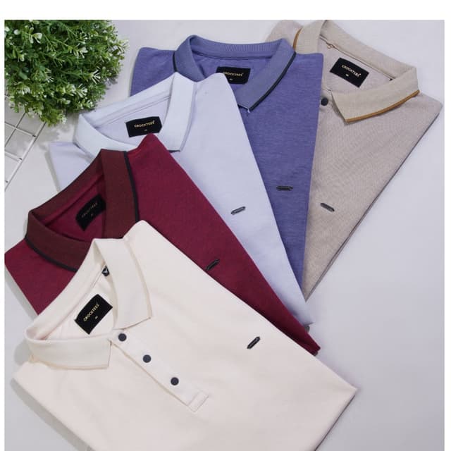 Variety of solid colors including cream, burgundy, light blue, purple, and beige. Polo Shirts