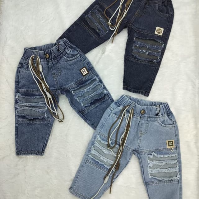 Various shades of blue denim with patches of lighter denim, and brown and white drawstrings Jeans