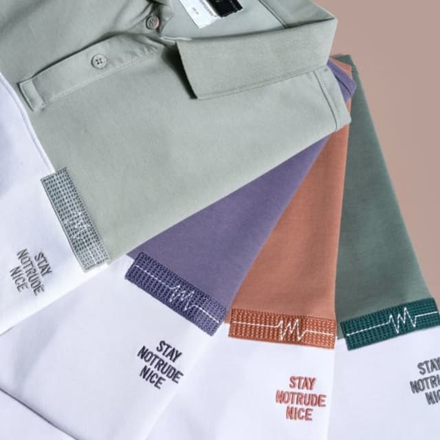 Various pastel colors including white, sage green, lavender, burnt orange, and forest green Polo Shirt