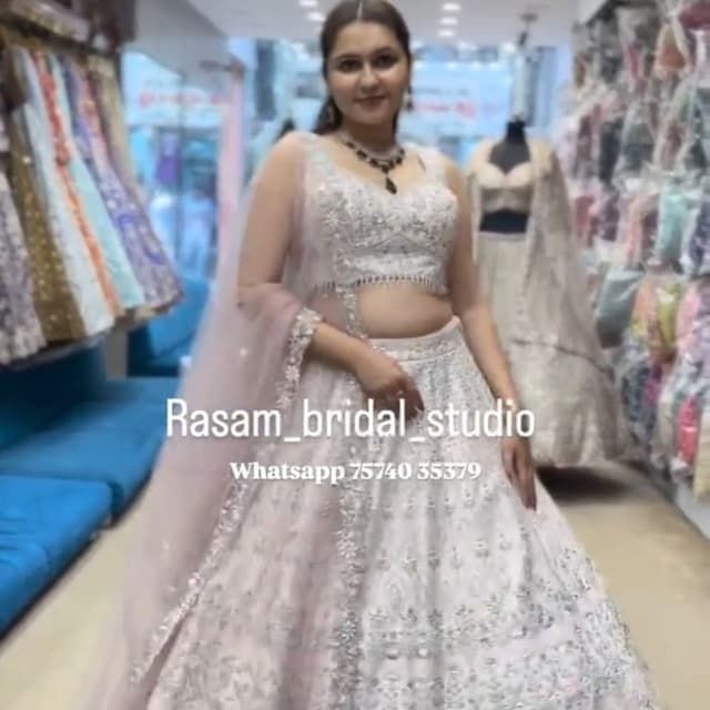 Ivory and subtle pastel hues (possibly light pink or mint green) for embroidery Lehenga Choli