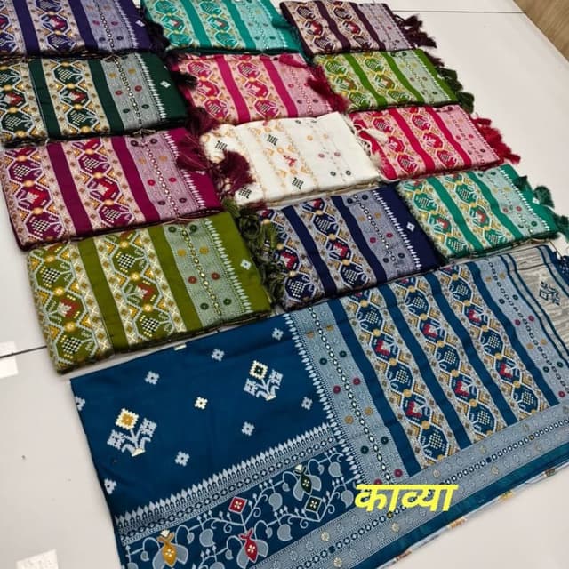 Various, including teal, green, pink, purple, white, and navy, with accents of yellow, red, and silver. Shawl