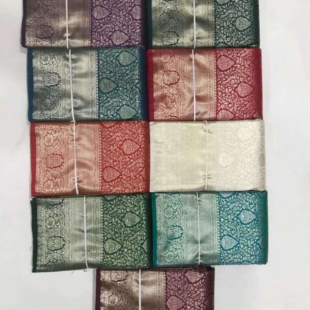 Various rich jewel tones including emerald green, deep red, purple, teal, gold, and silver. There are also combinations of these colors. Saree