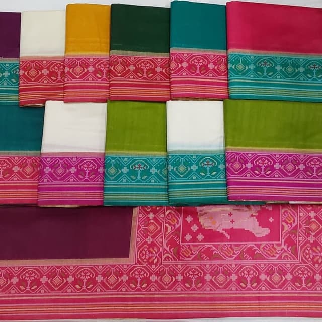 Vibrant and contrasting colors including yellow, green, teal, pink, white, and a deep magenta. Saree