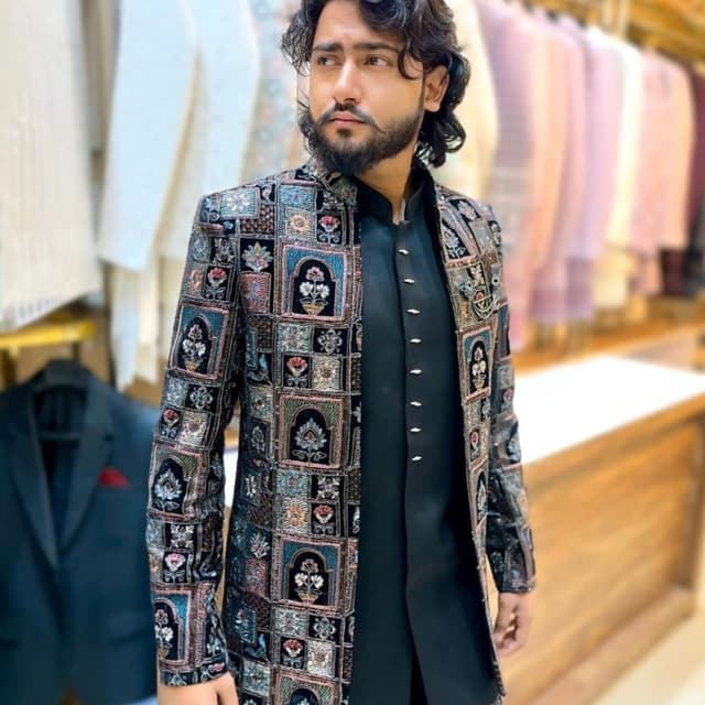 Black, with intricate patterns of teal, pink, gold, and other muted tones. Jacket