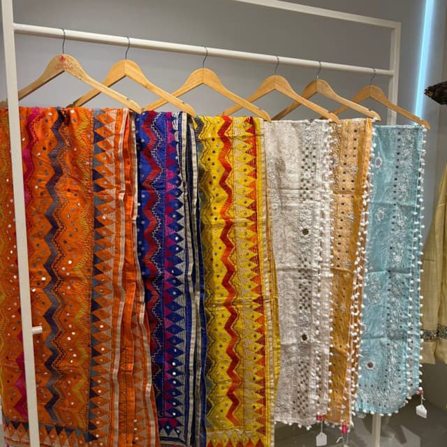 Vibrant and diverse, including orange, blue, yellow, white, and a light turquoise. Dupatta/Scarf