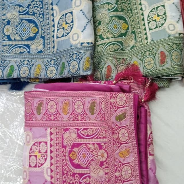 Various, including blue, green, and pink with gold accents Saree