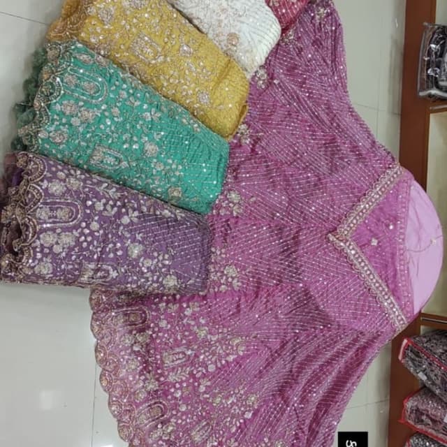 Various colors including pink, purple, yellow, green, and blue with silver embellishments Lehenga Choli