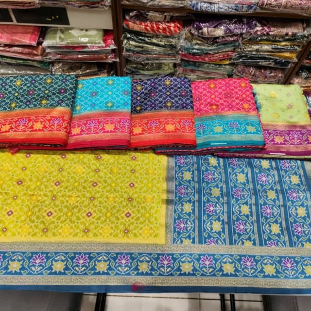 Vibrant and diverse, featuring combinations of blue, turquoise, pink, red, and yellow with gold accents. Saree