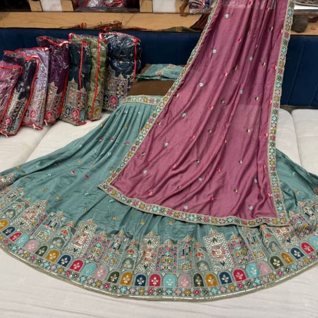 Teal green, dusty rose, multi-colored border with accents of pink, blue, yellow, and silver Lehenga Choli