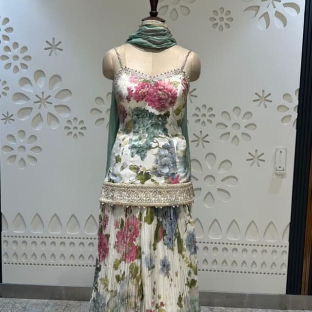 White with floral prints in pink, green, and blue, complemented by a sea-green dupatta and gold embellishments Lehenga Choli Set with Dupatta
