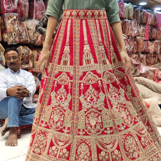 Red with gold and green embellishments Lehenga