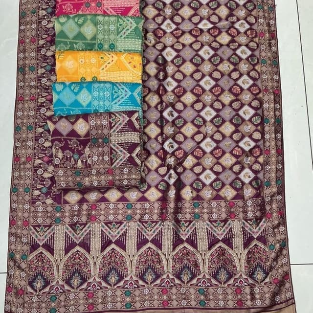 Deep purple with intricate patterns in gold, silver, pink, green, yellow, and teal. Unstitched Fabric (likely for a Salwar Kameez or Lehenga Choli set)